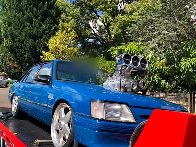 Blue VK Commodore with a supercharger blower on our tilt tray